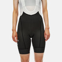 Bib shorts Velo Store Mx Mechanism para dama en color negro con tirantes de malla blanca y diseño aerodinámico.