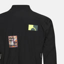 Chaqueta negra Velo Store Mx T.K.O. Essential con parches gráficos y detalles técnicos de ciclismo