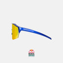 Gafas de ciclismo Velo Store Mx KOO Alibi con montura azul metálico y lente Zeiss Red Mirror de alto rendimiento.