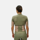 Vista trasera de mujer con jersey de ciclismo Pas Normal Studios Escapism color verde oliva claro y detalles beige