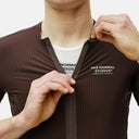 Jersey de ciclismo Velo Store Mx Pas Normal Studios en color oliva oscuro con textura técnica y cremallera frontal