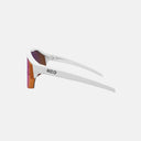 Lentes deportivos Velo Store Mx Koo Alibi con montura blanca y lentes fotocromáticos de tono rojizo, vista lateral.