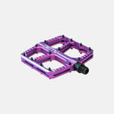 Pedales Velo Store Mx Deity Flat Trak morados de aluminio con diseño cóncavo y pines de agarre para MTB.